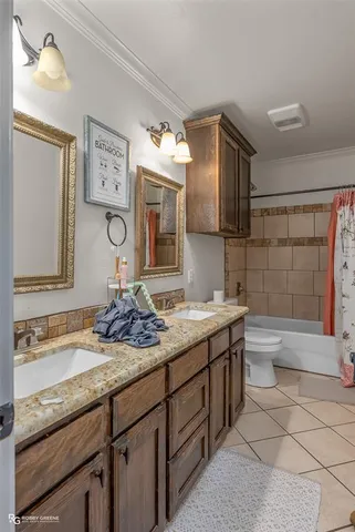 a bathroom with a granite countertop sink mirror and bathtub