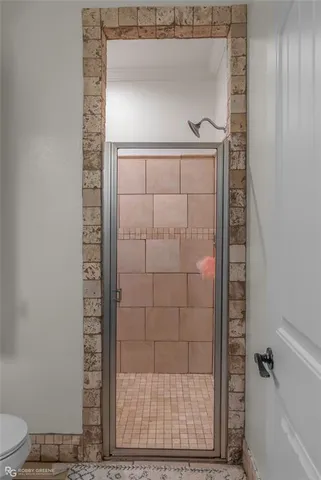 a bathroom with a glass shower door