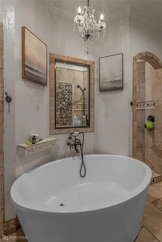a bathroom with a tub a sink and mirror