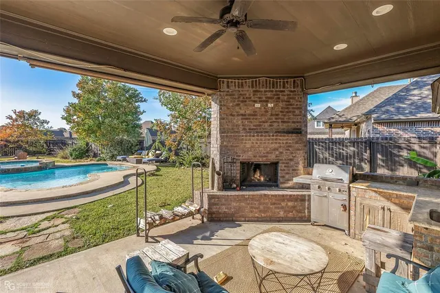 a living room with patio furniture and a fireplace