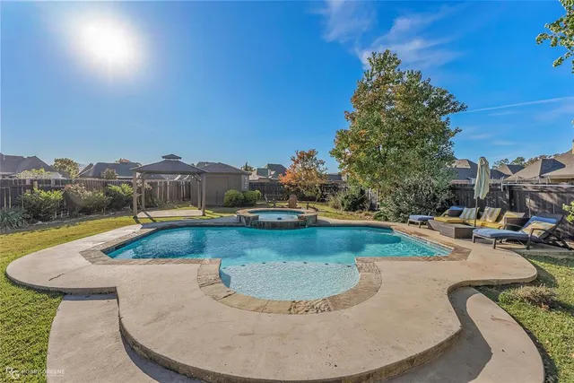 a view of a swimming pool with an outdoor seating