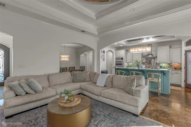 a living room with furniture and view of kitchen