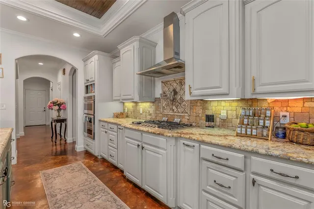 a kitchen with granite countertop a sink stainless steel appliances and cabinets