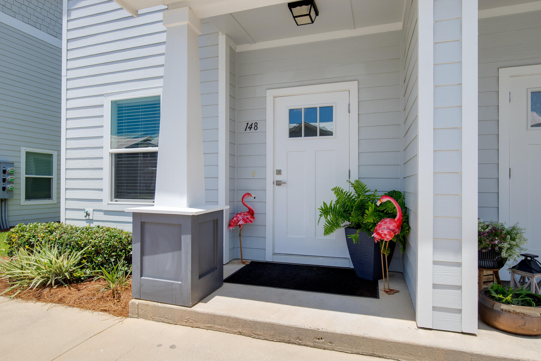 148 North Sand Palm Road Freeport, FL 32439 - Photo 2 of 17 a potted plant sitting in front of a house