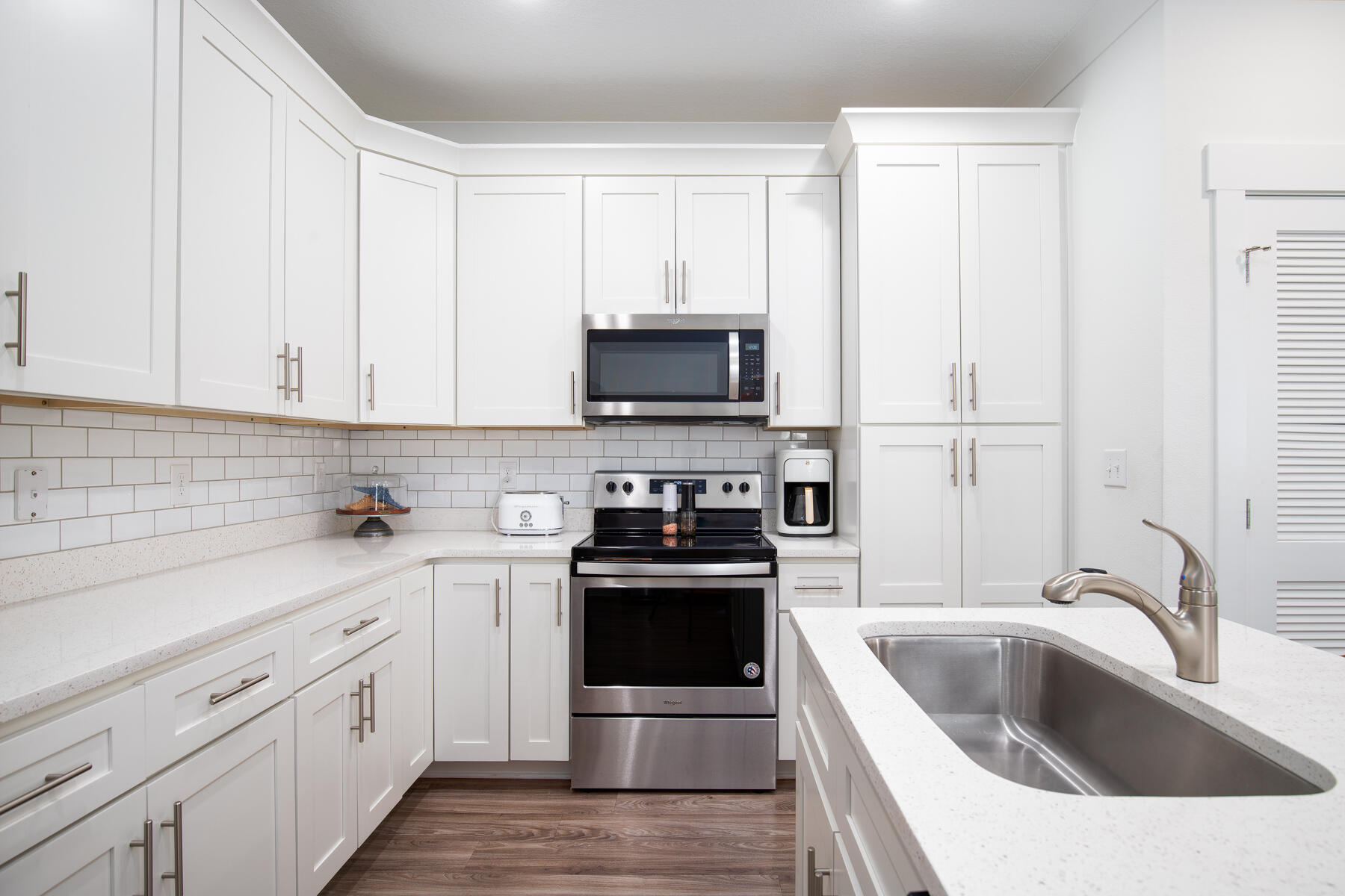 148 North Sand Palm Road Freeport, FL 32439 - Photo 8 of 17 a kitchen with stainless steel appliances granite countertop a stove and white cabinets