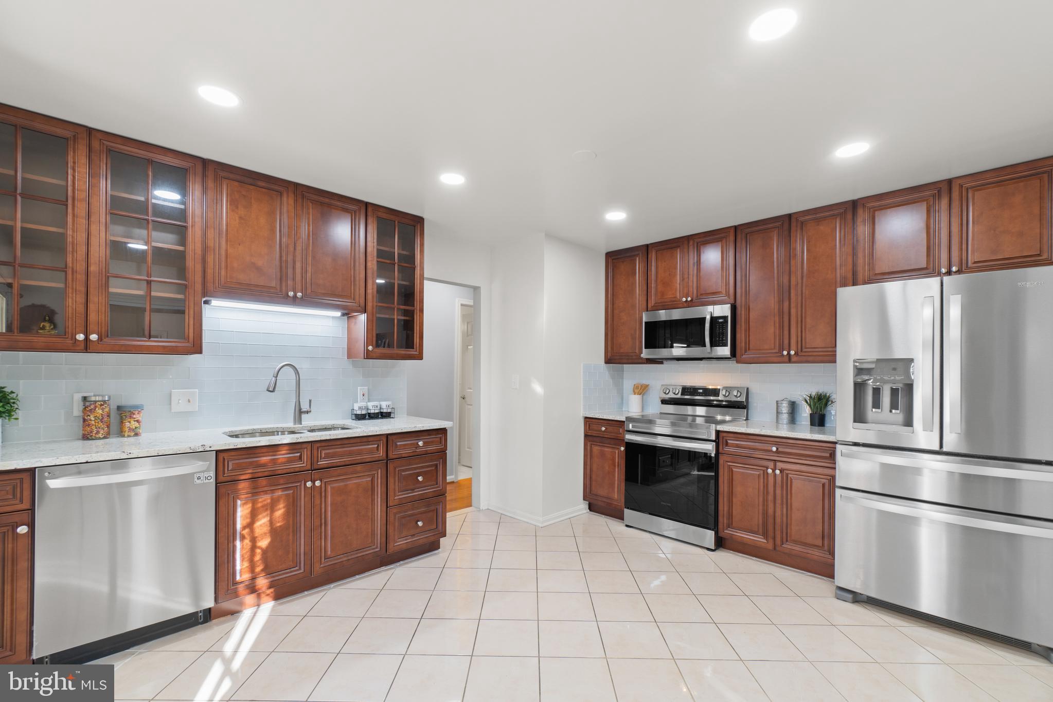 2430 Lyttonsville Road Silver Spring, MD 20910 - Photo 11 of 53 a kitchen with stainless steel appliances granite countertop a refrigerator sink and cabinets