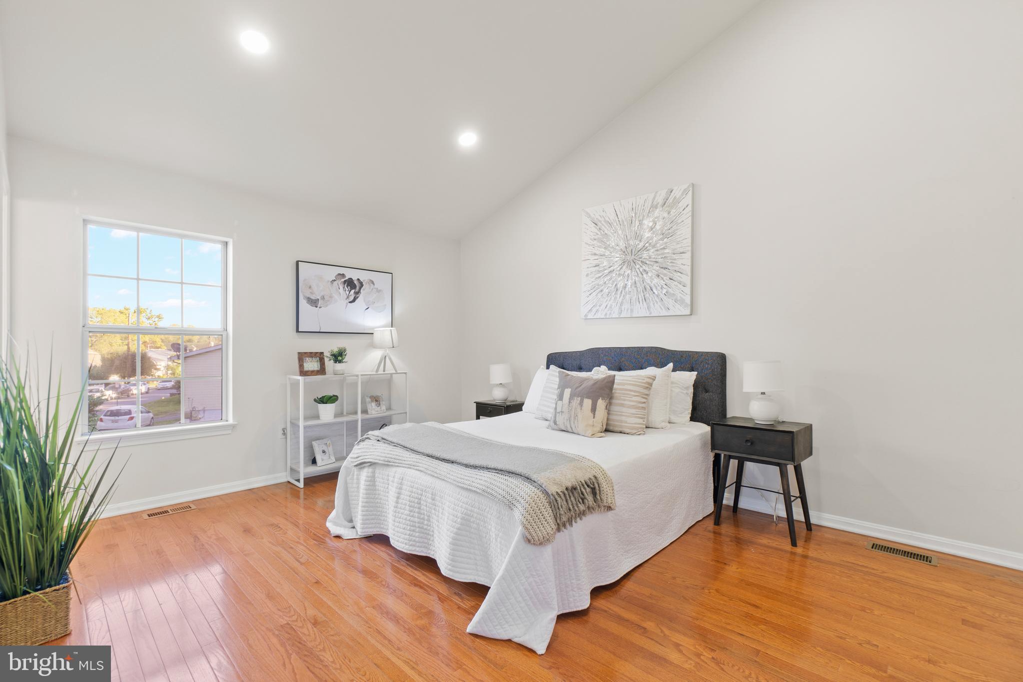 2430 Lyttonsville Road Silver Spring, MD 20910 - Photo 14 of 53 a bedroom with a bed and a table with potted plant