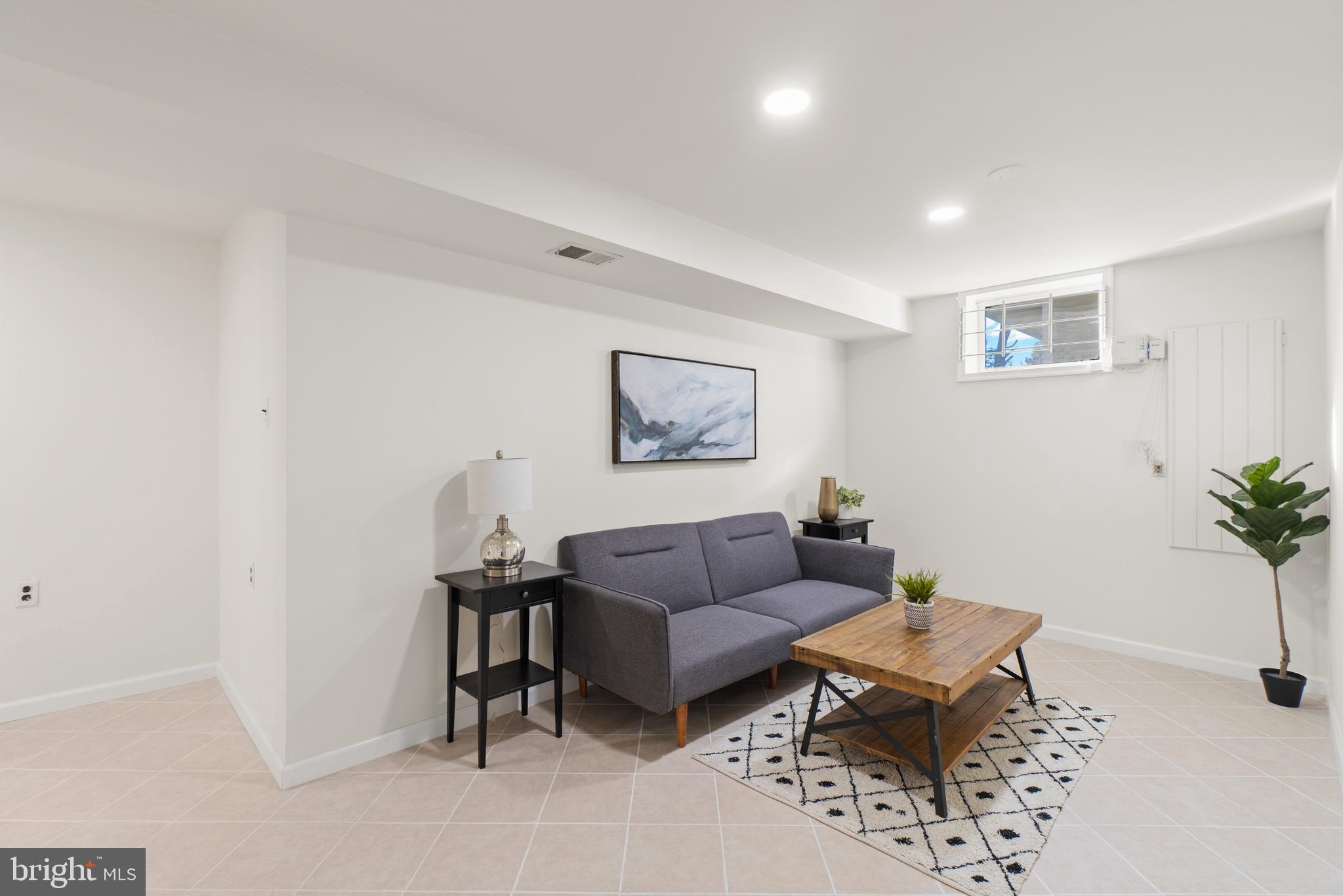 2430 Lyttonsville Road Silver Spring, MD 20910 - Photo 32 of 53 a living room with furniture and a potted plant