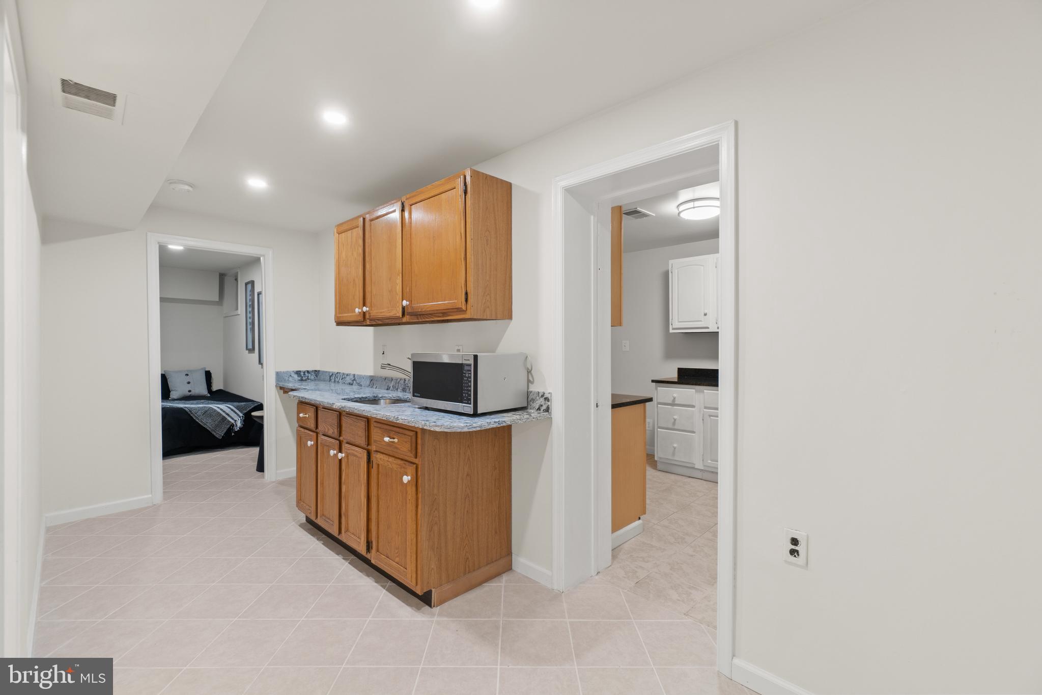 2430 Lyttonsville Road Silver Spring, MD 20910 - Photo 34 of 53 a kitchen with stainless steel appliances granite countertop a stove a sink and a refrigerator