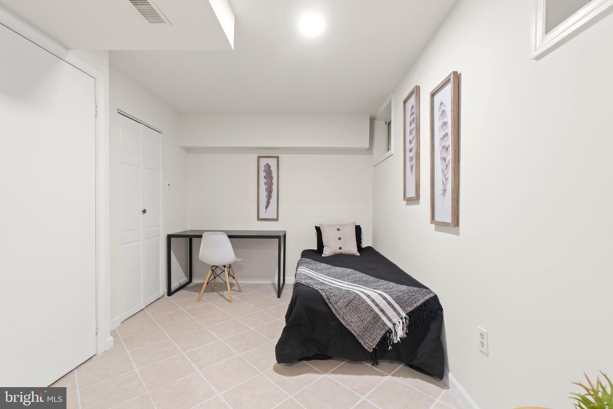 2430 Lyttonsville Road Silver Spring, MD 20910 - Photo 36 of 53 a bedroom with a bed and a chair