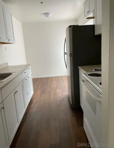 a kitchen with stainless steel appliances a refrigerator stove and sink