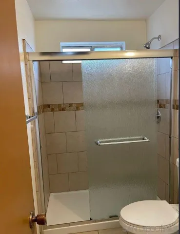 a bathroom with a shower and a toilet