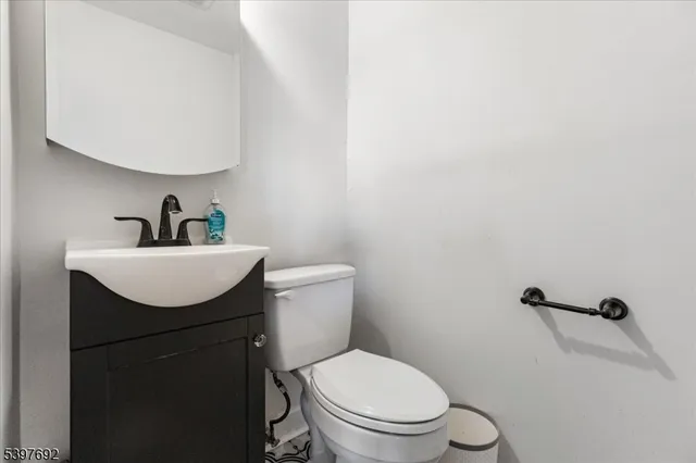 a bathroom with a toilet a sink and mirror