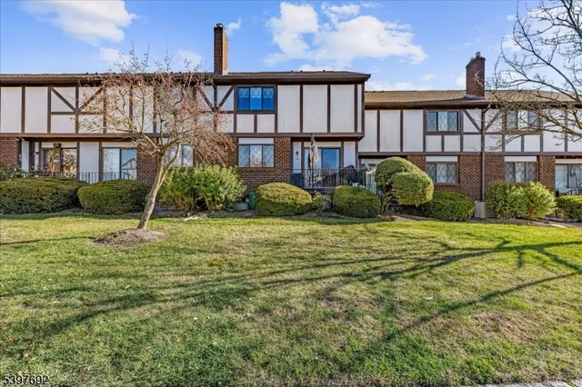 a view of a house with backyard and porch