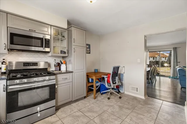 a view of kitchen with sink stove and furniture