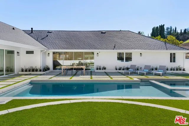a view of a house with pool table and chairs
