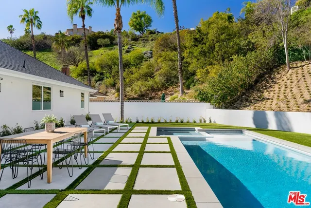 a view of swimming pool with seating space