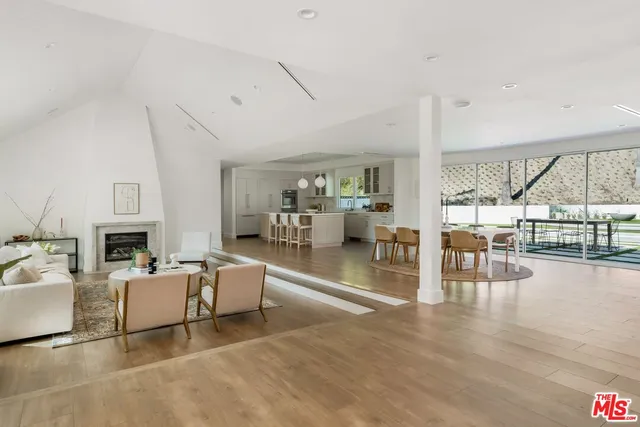 a living room with furniture a fireplace and a table