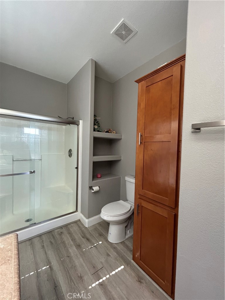 10550 Western Avenue, Unit 32 Stanton, CA 90680 - Photo 10 of 31 a bathroom with a granite countertop toilet and a shower