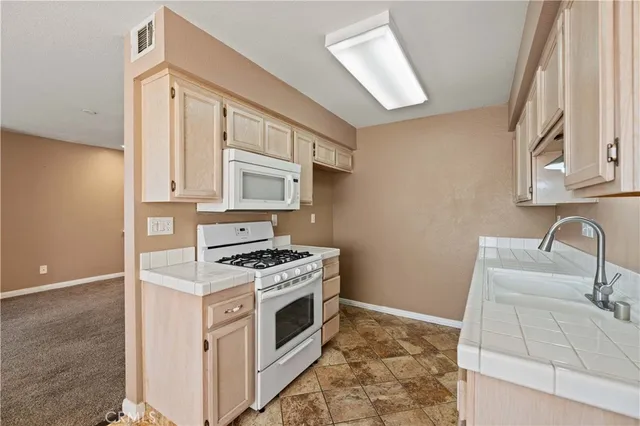 a kitchen with a stove top oven and sink