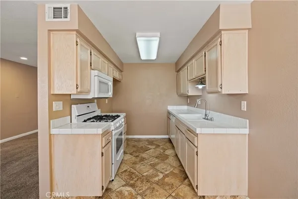 a kitchen with stainless steel appliances granite countertop a stove and a sink
