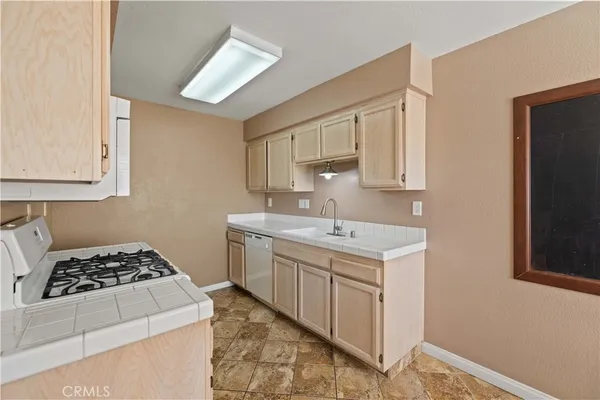 a kitchen with a sink stove and cabinets
