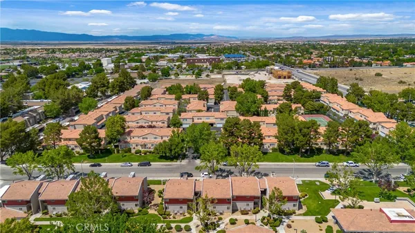 an aerial view of residential building with outdoor space and lake view