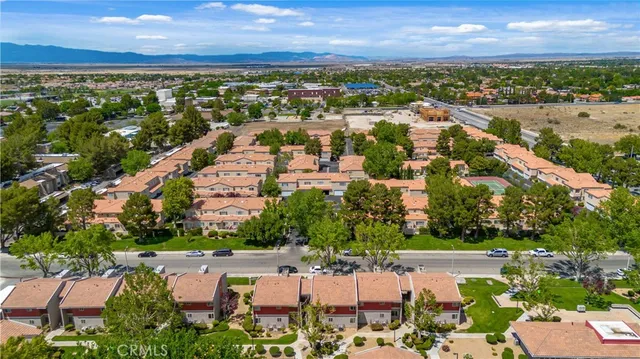 an aerial view of residential building with outdoor space and lake view