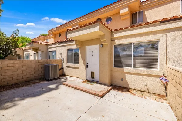a view of a house with wooden fence