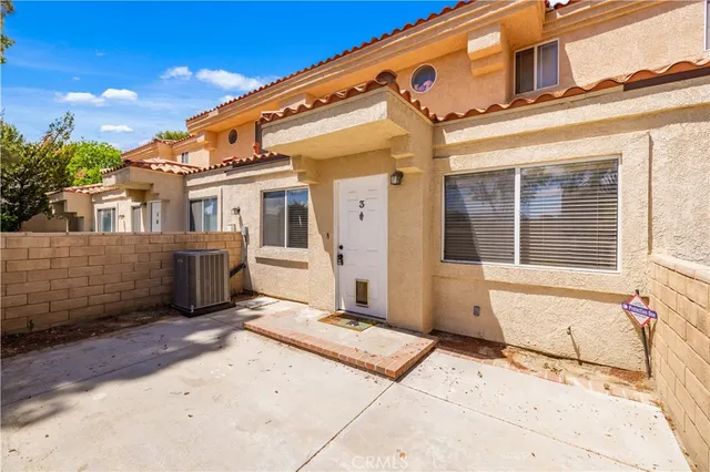 a view of a house with wooden fence