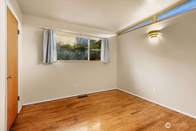 18822 Olympic View Drive Edmonds, WA 98020 - Photo 12 of 20 a view of empty room with wooden floor and fan