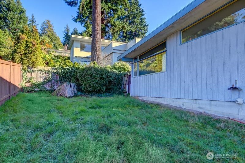 18822 Olympic View Drive Edmonds, WA 98020 - Photo 17 of 20 a view of a backyard with potted plants and wooden fence