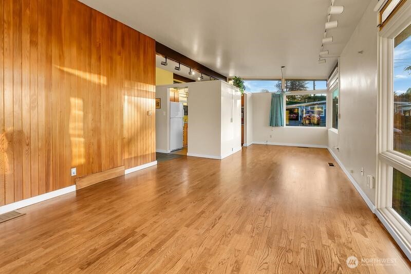 18822 Olympic View Drive Edmonds, WA 98020 - Photo 4 of 20 a view of an empty room with wooden floor and a window