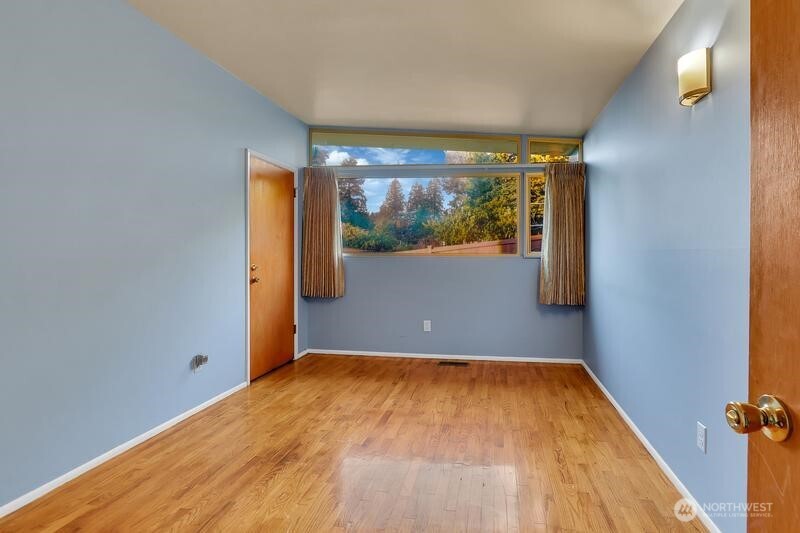 18822 Olympic View Drive Edmonds, WA 98020 - Photo 10 of 20 a view of empty room with wooden floor and fan
