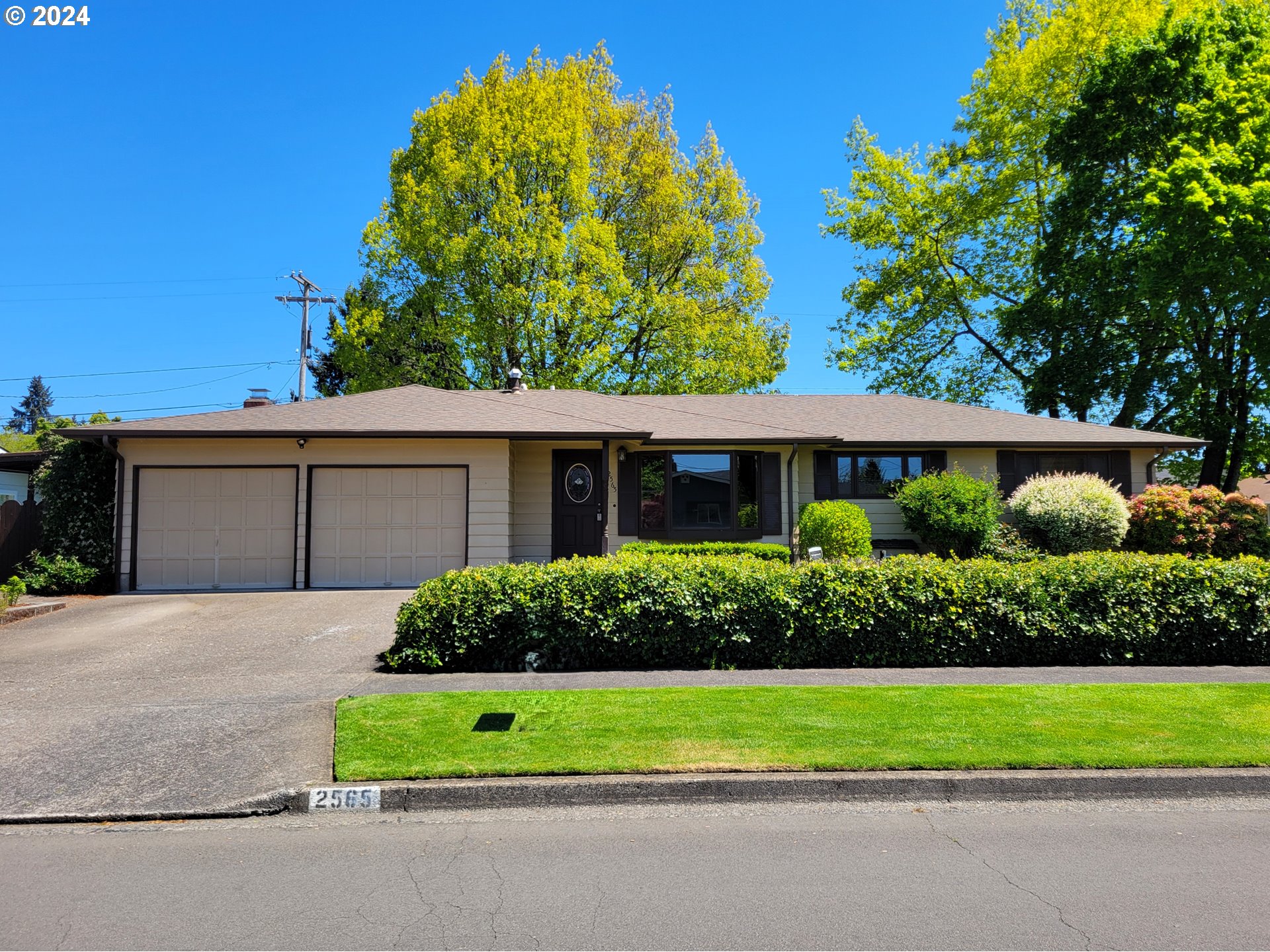 a front view of a house with a garden