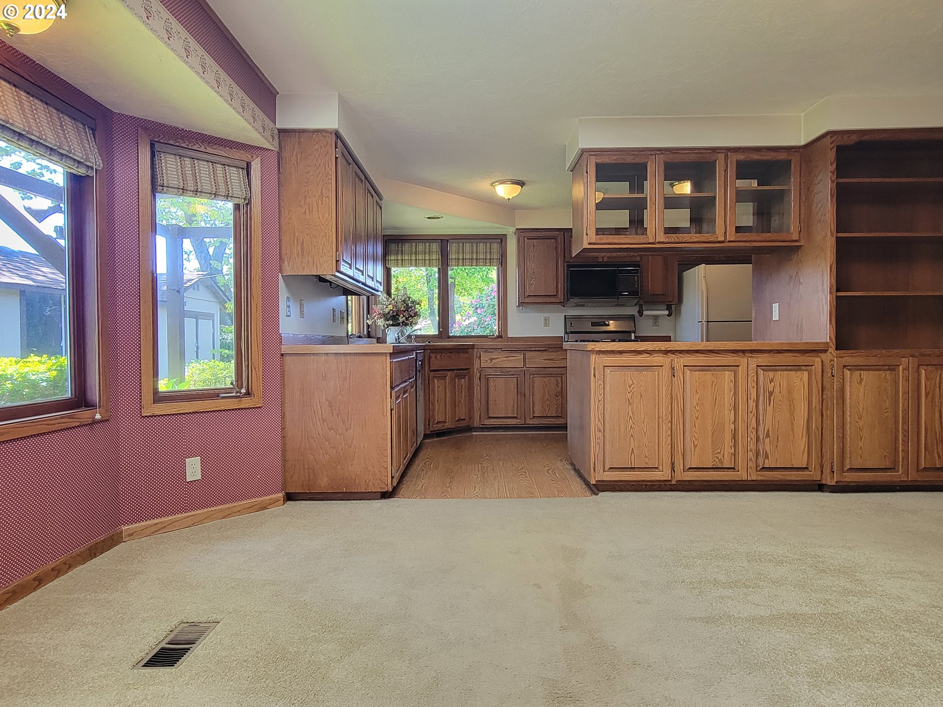 2565 Newcastle Street Eugene, OR 97404 - Photo 17 of 38 a kitchen with stainless steel appliances granite countertop a stove a sink and a refrigerator
