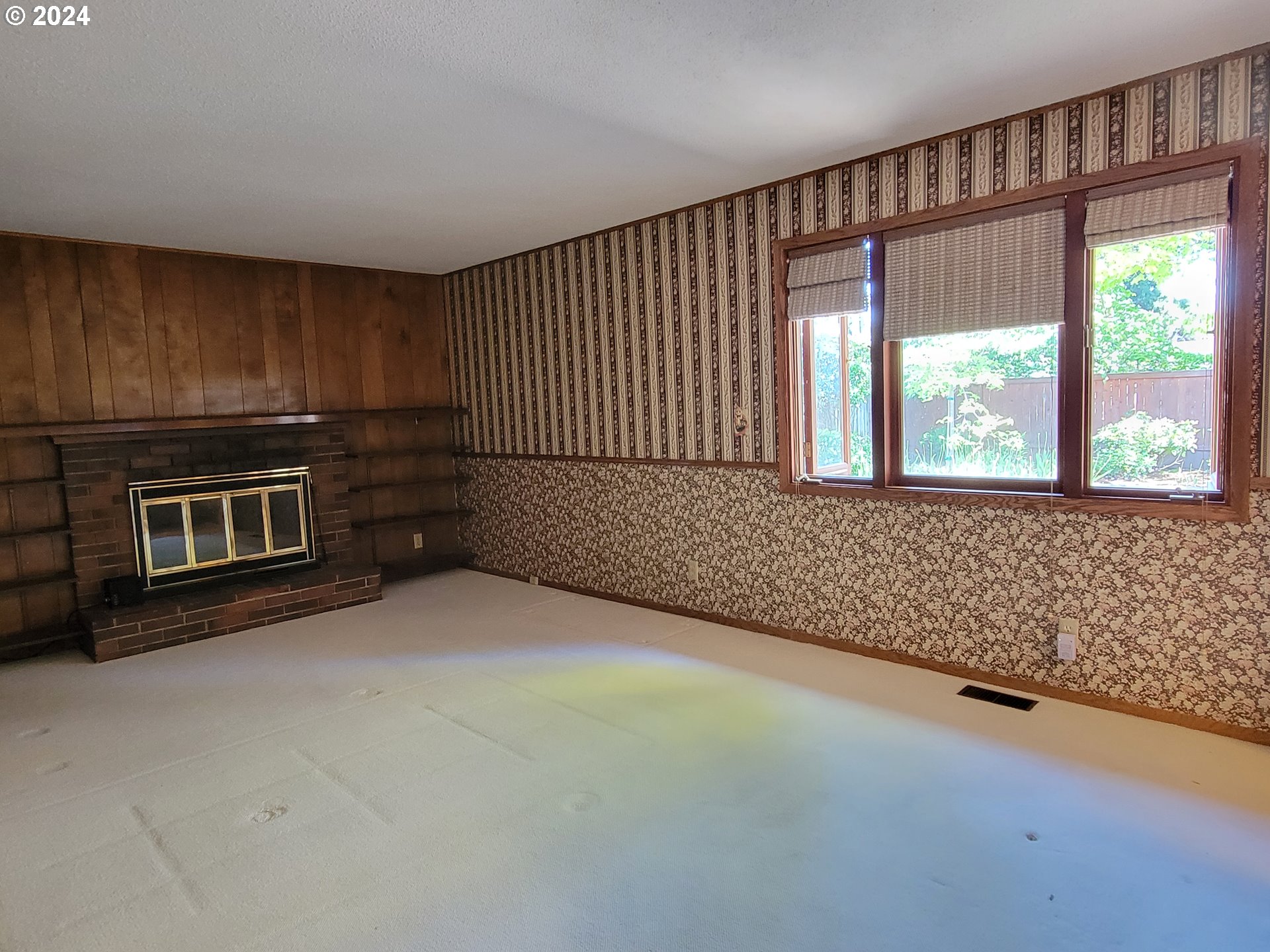 2565 Newcastle Street Eugene, OR 97404 - Photo 26 of 38 a view of an empty room with a fireplace and a window