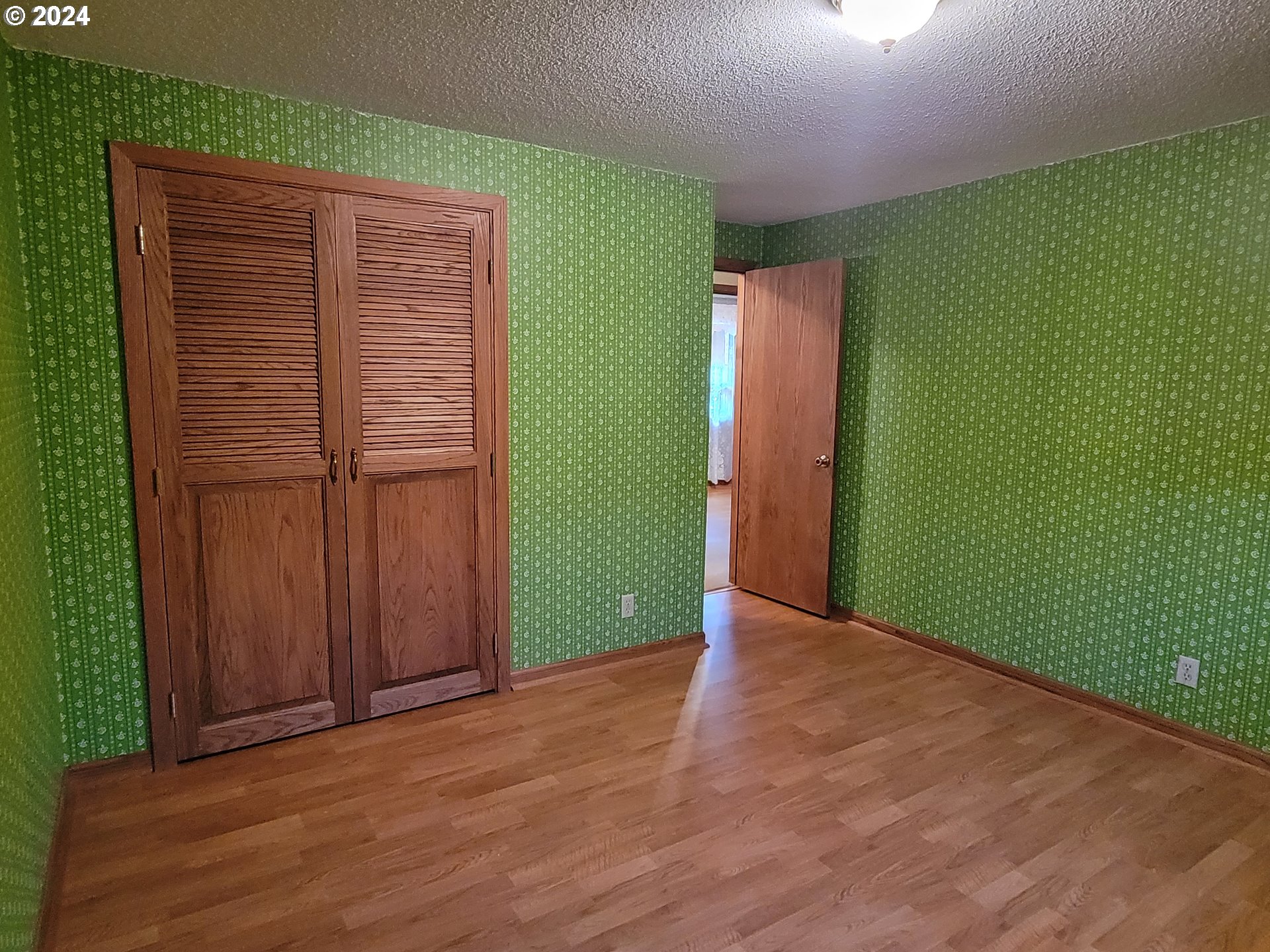 2565 Newcastle Street Eugene, OR 97404 - Photo 32 of 38 an empty room with wooden floor and closet area