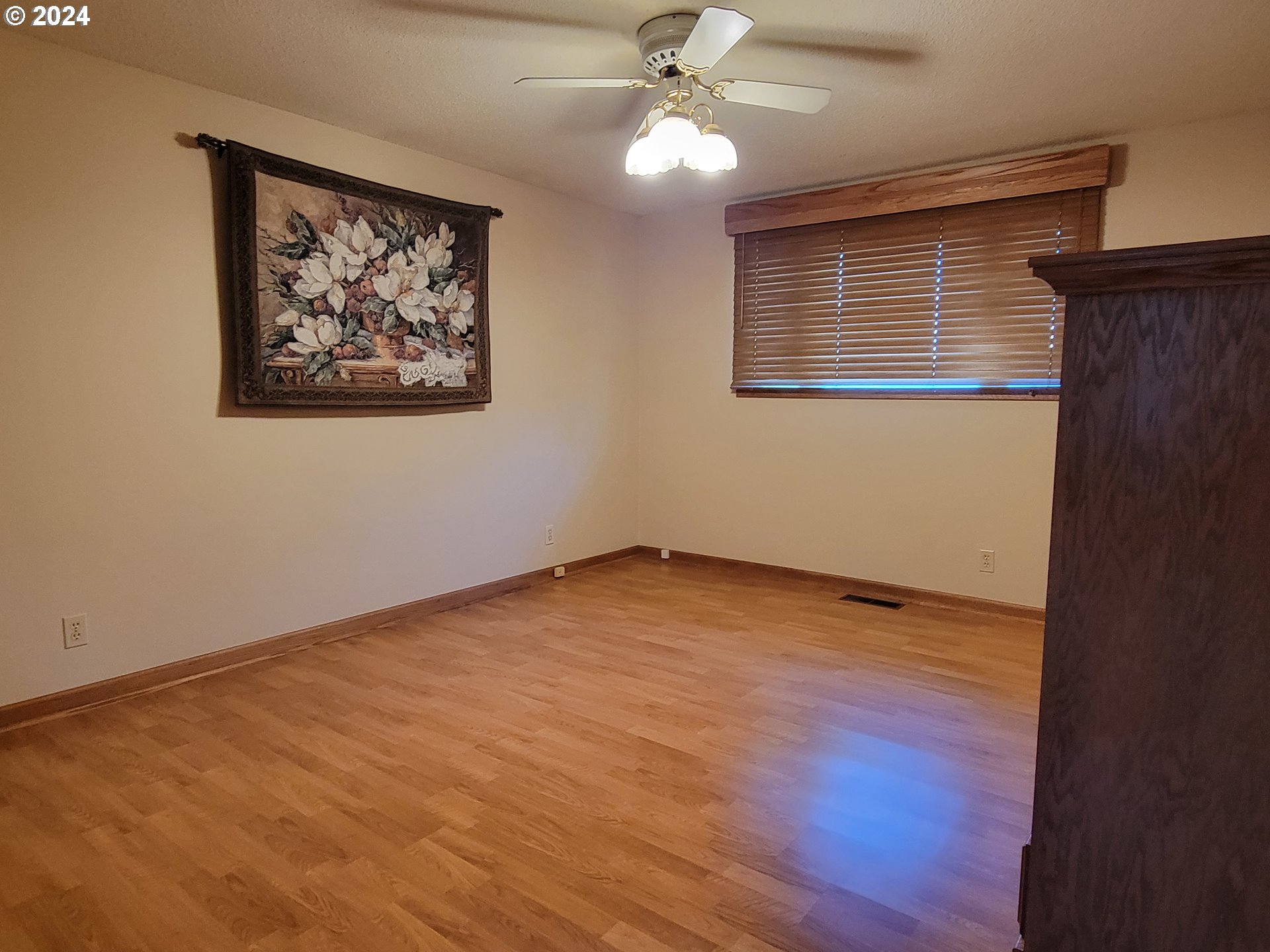 2565 Newcastle Street Eugene, OR 97404 - Photo 33 of 38 a view of an empty room with wooden floor and ceiling fan