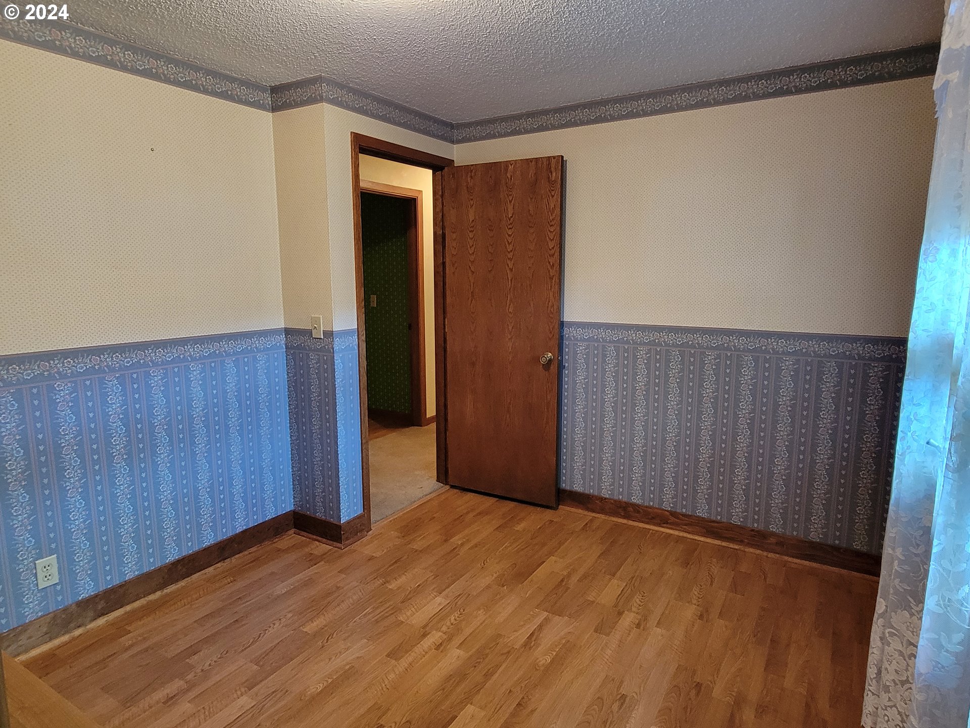 2565 Newcastle Street Eugene, OR 97404 - Photo 36 of 38 a view of an empty room with wooden floor