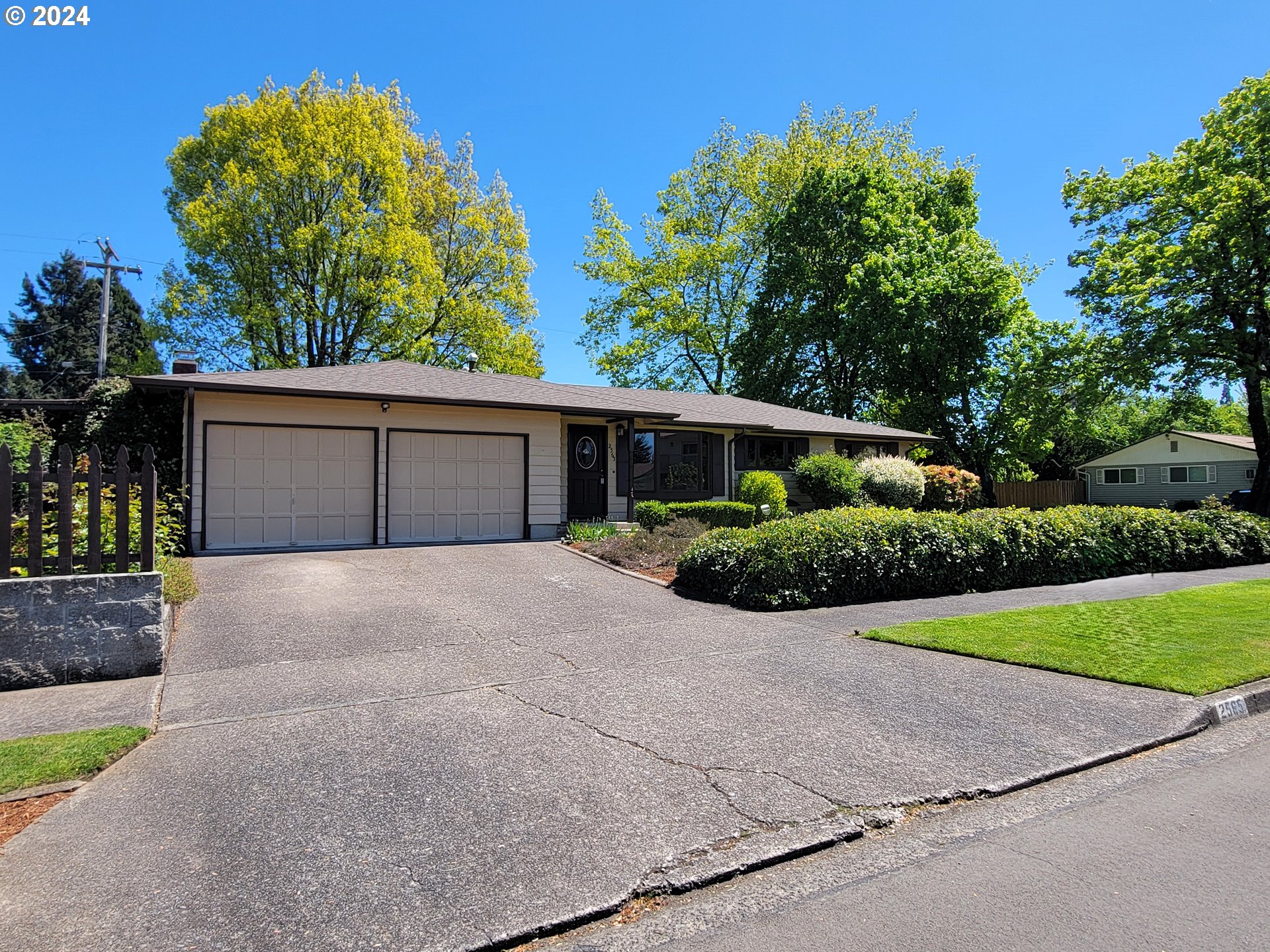 2565 Newcastle Street Eugene, OR 97404 - Photo 4 of 38 a front view of house with yard and trees in the background