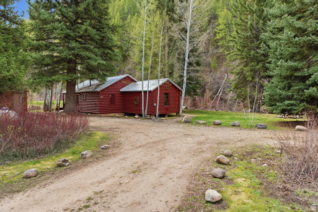 6631 Pine Springs Road Kamas, UT 84036 - Photo 35 of 48 View of property exterior with faux log siding, a lawn, and dirt driveway