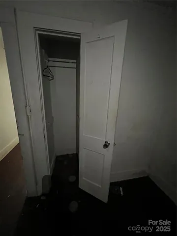 a view of a room with an empty space and wooden floor