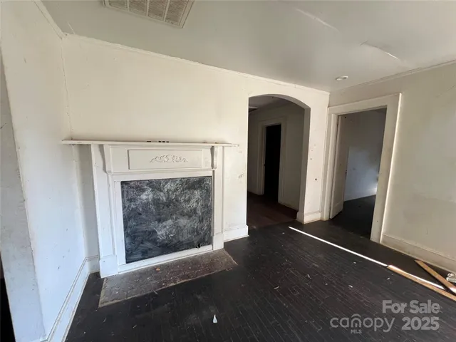 a view of an empty room and fire place