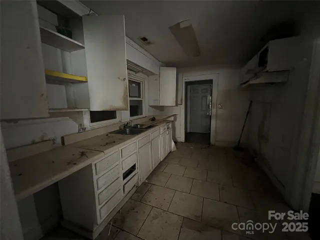 a kitchen with a sink and cabinets