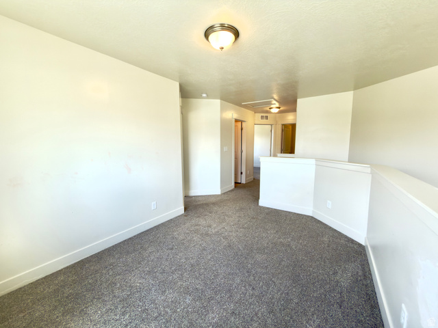 1823 South Longview Road Santaquin, UT 84655 - Photo 32 of 69 Upper-level landing featuring textured gray carpeting and white painted walls