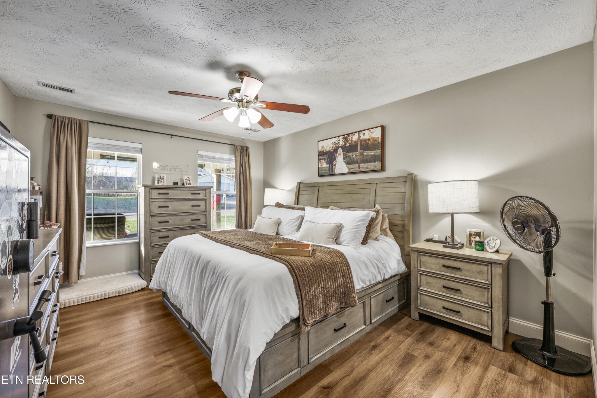 2312 Crestpark Road Knoxville, TN 37912 - Photo 21 of 33 a spacious bedroom with a bed a dresser and wooden floor