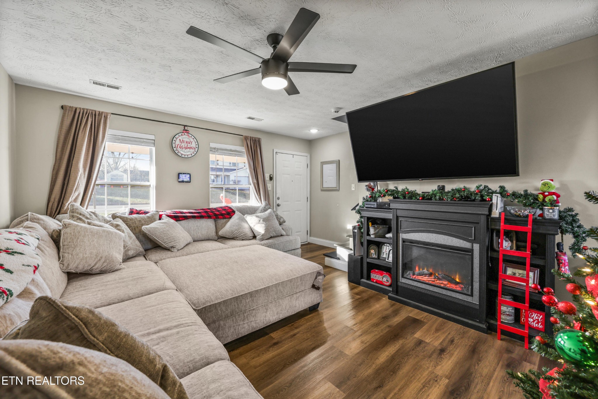 2312 Crestpark Road Knoxville, TN 37912 - Photo 9 of 33 a living room with furniture a flat screen tv and a fireplace