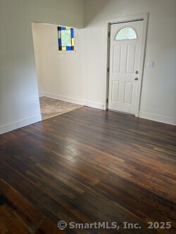 22 Dr Aaron B Samuels Boulevard, Unit 2 Danbury, CT 06810 - Photo 3 of 10 an empty room with wooden floor and mirror