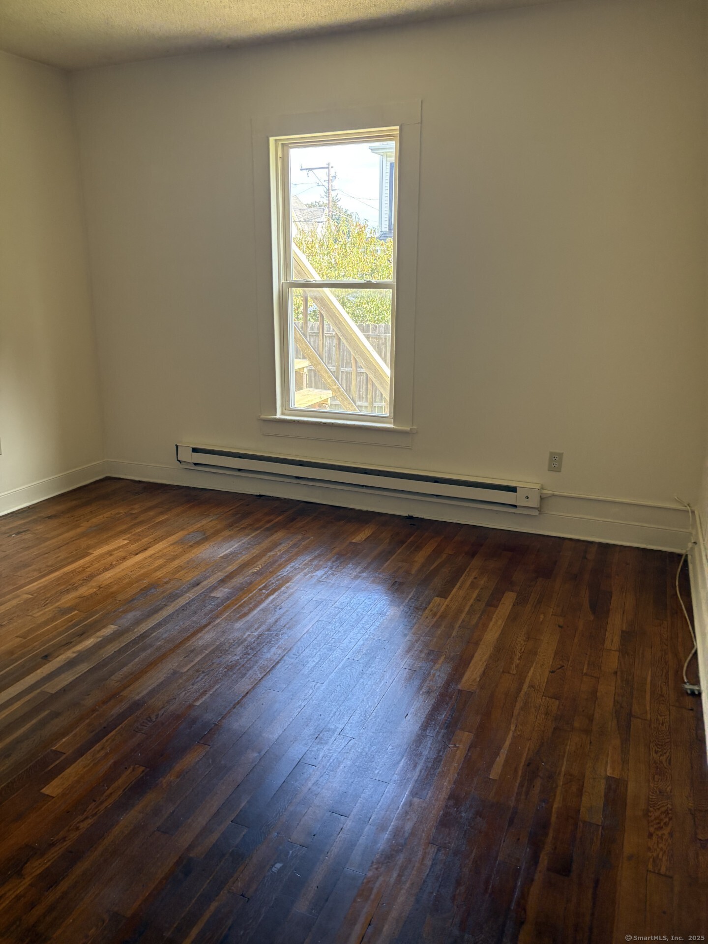 22 Dr Aaron B Samuels Boulevard, Unit 2 Danbury, CT 06810 - Photo 4 of 10 an empty room with wooden floor and windows
